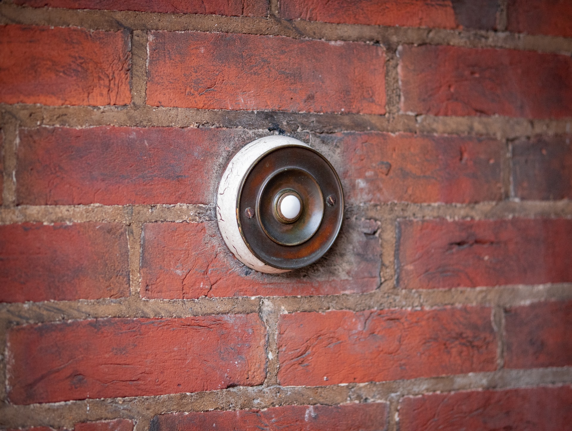 Brick house round doorbell with wear