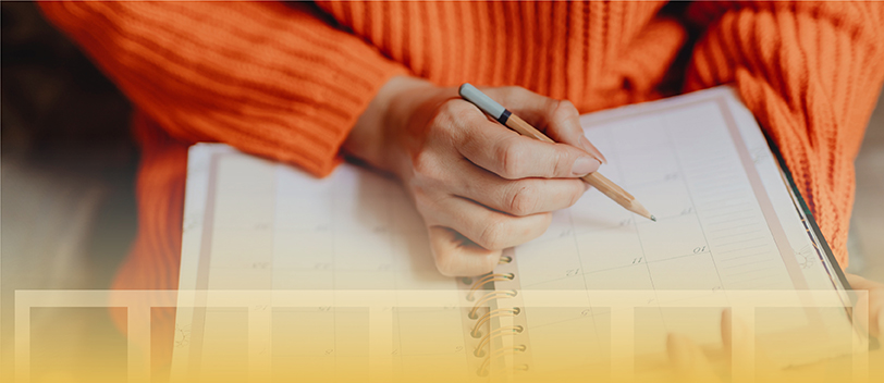 Woman working with a calendar with a digital overlay depicting Golden Spiral's philosophy of building a winning content calendar